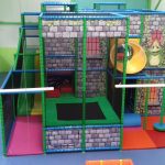 Frog King themed indoor playground with trampoline and 2 lane slide