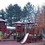 Wooden modular play structure with nine towers