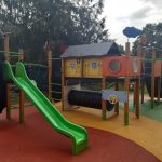 Playground complex with slides, climbing unit, bridge, swing, tunnel and pour-in-place rubber playground surfacing